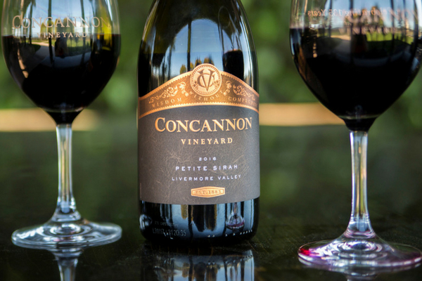 Concannon Vineyard Petite Sirah bottle with two glasses of wine