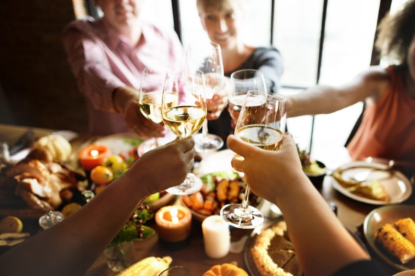 Family enjoying Thanksgiving with glasses of wine